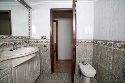 a bathroom with a sink and a toilet and a mirror at Cerquita de la Caleta by Gades Gestión in Cádiz