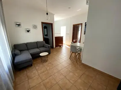 a living room with a couch and a table at Apartamento Hostal Mellizo in Lebrija