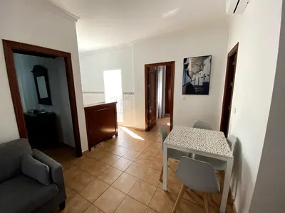 a living room with a table and a couch at Apartamento Hostal Mellizo in Lebrija