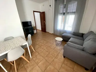 a living room with a couch and a table at Apartamento Hostal Mellizo in Lebrija
