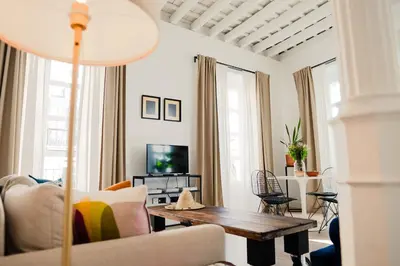 a living room with a couch and a table at Casa Miguel - Apartamento 3 in Sanlúcar de Barrameda