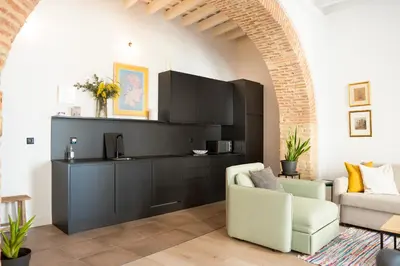a living room with a couch and a chair at Casa Miguel - Apartamento 2 in Sanlúcar de Barrameda