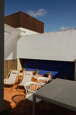 a group of chairs and tables on a patio at Casa Miguel - Apartamento 4 in Sanlúcar de Barrameda