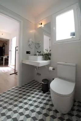 a bathroom with a toilet and a sink at Casa Miguel - Apartamento 4 in Sanlúcar de Barrameda