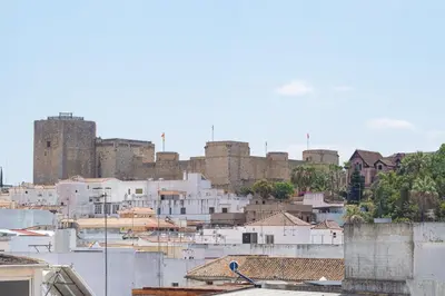 a view of a city with a castle in the background at Casa Miguel - Apartamento 5 in Sanlúcar de Barrameda