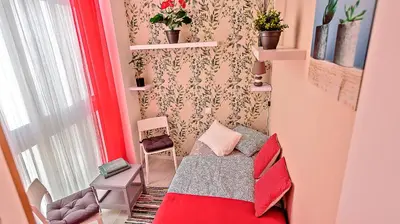 a small room with a bed and a chair at Palacios Deluxe Apartment with Elevator in El Puerto de Santa María