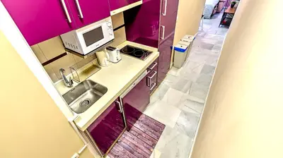a small kitchen with a sink and a microwave at Palacios Deluxe Apartment with Elevator in El Puerto de Santa María