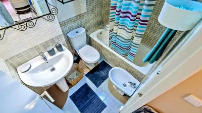 a bathroom with a sink and a toilet and a tub at Palacios Deluxe Apartment with Elevator in El Puerto de Santa María