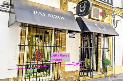 a store front with a black awning on a building at Palacios Deluxe Apartment with Elevator in El Puerto de Santa María