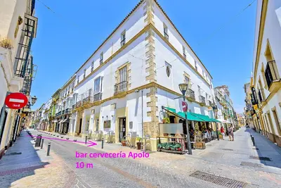 a large white building on a city street at Palacios Deluxe Apartment with Elevator in El Puerto de Santa María