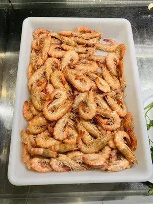 a white tray filled with shrimp on a table at Casa Miguel - Apartamento 6 in Sanlúcar de Barrameda