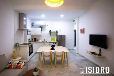 a kitchen and living room with a table and chairs at El patio de San Isidro by Gades Gestión in Cádiz