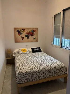 a bedroom with a bed with a map on the wall at El patio de San Isidro by Gades Gestión in Cádiz