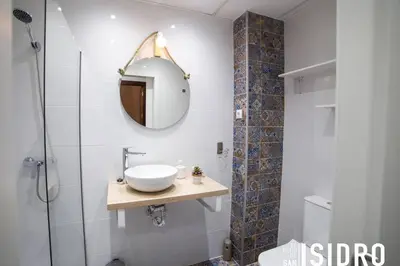 a bathroom with a sink and a mirror at El patio de San Isidro by Gades Gestión in Cádiz
