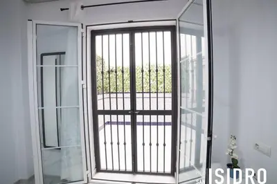 a sliding glass door with a view of a balcony at El patio de San Isidro by Gades Gestión in Cádiz