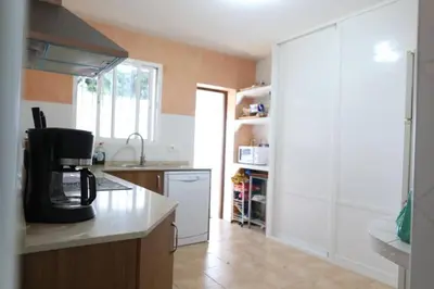 a kitchen with a coffee maker on a counter at Chalet con piscina, amplio jardin y aire acondicionado in Chiclana de la Frontera