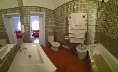 a bathroom with a tub and a toilet and a sink at GirasolesV in Sanlúcar de Barrameda