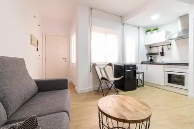 a living room with a couch and a table at Allo Apartments Francos I Centro 2 Habitaciones in Jerez de la Frontera