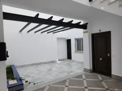 a room with a black door and a white wall at Allo Apartments Francos I Centro 2 Habitaciones in Jerez de la Frontera