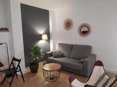 a living room with a couch and a table and chairs at Allo Apartments Francos I Centro 2 Habitaciones in Jerez de la Frontera