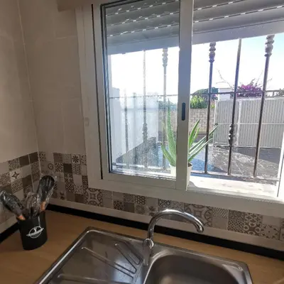 a kitchen sink and a window with a view at Brisa marina novo sancti petri in Chiclana de la Frontera