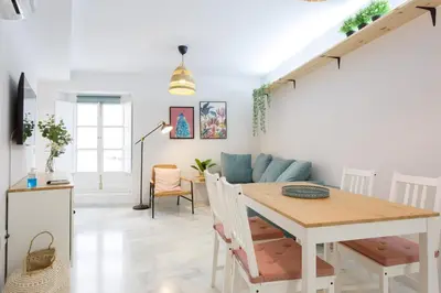 a living room with a table and a couch at Apartamento El NOBLE by Cadiz4Rentals in Cádiz