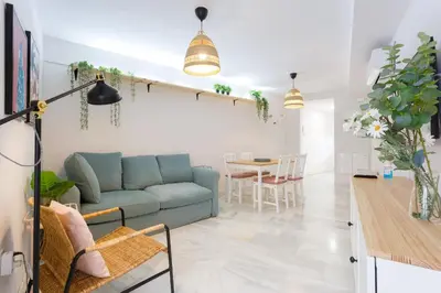 a living room with a blue couch and a table at Apartamento El NOBLE by Cadiz4Rentals in Cádiz