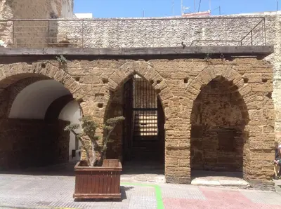 a brick building with a potted plant in front of it at Apartamento El NOBLE by Cadiz4Rentals in Cádiz