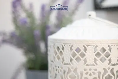 a white vase with a sign on top of it at Piso Nao Victoria in Sanlúcar de Barrameda