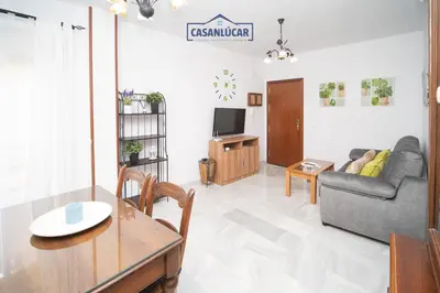 a living room with a couch and a table at Piso Nao Victoria in Sanlúcar de Barrameda