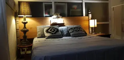 a bedroom with a bed with pillows on it at habitacion en casa kenya in Jerez de la Frontera