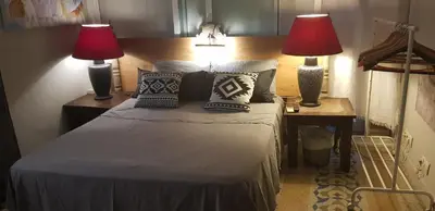 a bedroom with a bed with two lamps on it at habitacion en casa kenya in Jerez de la Frontera