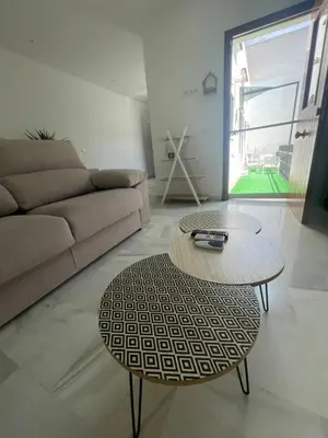 a living room with a couch and a coffee table at Casa Palacio Sanlúcar Home in Sanlúcar de Barrameda