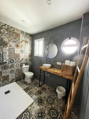 a bathroom with two toilets and a sink and a mirror at Casa Palacio Sanlúcar Home in Sanlúcar de Barrameda