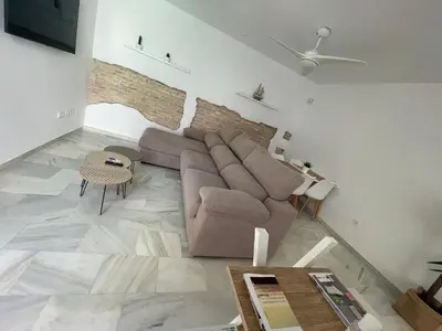 a living room with a couch and a table at Casa Palacio Sanlúcar Home in Sanlúcar de Barrameda
