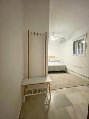a room with a bed and a chair in it at Casa Palacio Sanlúcar Home in Sanlúcar de Barrameda