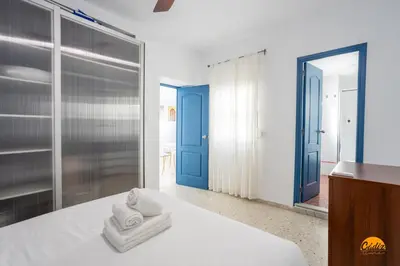 a bedroom with a bed with towels on it at Apartamento Encanto Gaditano con Terraza by Cádiz Time in Cádiz