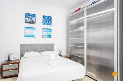 a bedroom with a white bed and a shower at Apartamento Encanto Gaditano con Terraza by Cádiz Time in Cádiz