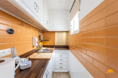 a small kitchen with a counter and a sink at Apartamento Encanto Gaditano con Terraza by Cádiz Time in Cádiz