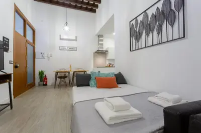two beds in a room with a living room at CRUISE Adapted Apartment by Cadiz4Rentals in Cádiz
