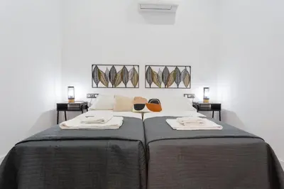 a bedroom with a bed with sunglasses on it at CRUISE Adapted Apartment by Cadiz4Rentals in Cádiz