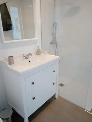 a bathroom with a white sink and a mirror at CASA DEL ANTICUARIO APARTMENTS in Cádiz