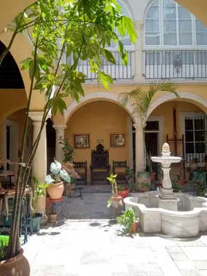 a courtyard with a fountain in a building at CASA DEL ANTICUARIO APARTMENTS in Cádiz