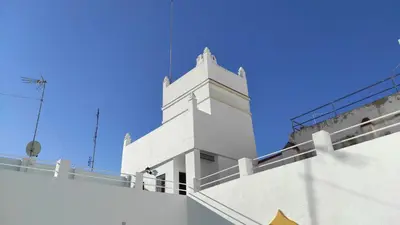 a white building with a blue sky in the background at CASA DEL ANTICUARIO APARTMENTS in Cádiz