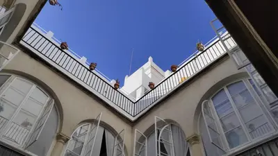 a balcony on the side of a building at CASA DEL ANTICUARIO APARTMENTS in Cádiz