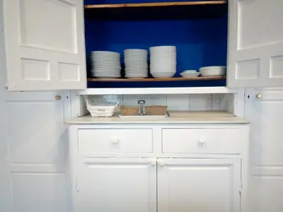 a kitchen with a sink and white cabinets at CASA DEL ANTICUARIO APARTMENTS in Cádiz