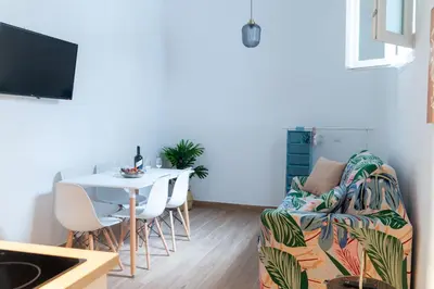 a living room with a couch and a table at Apartamentos El Alcazar de Jerez in Jerez de la Frontera