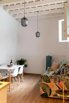 a living room with a table and a couch at Apartamentos El Alcazar de Jerez in Jerez de la Frontera