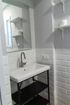 a white bathroom with a sink and a mirror at Apartamentos El Alcazar de Jerez in Jerez de la Frontera