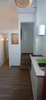 a kitchen with a sink and a counter top at Apartamentos El Alcazar de Jerez in Jerez de la Frontera
